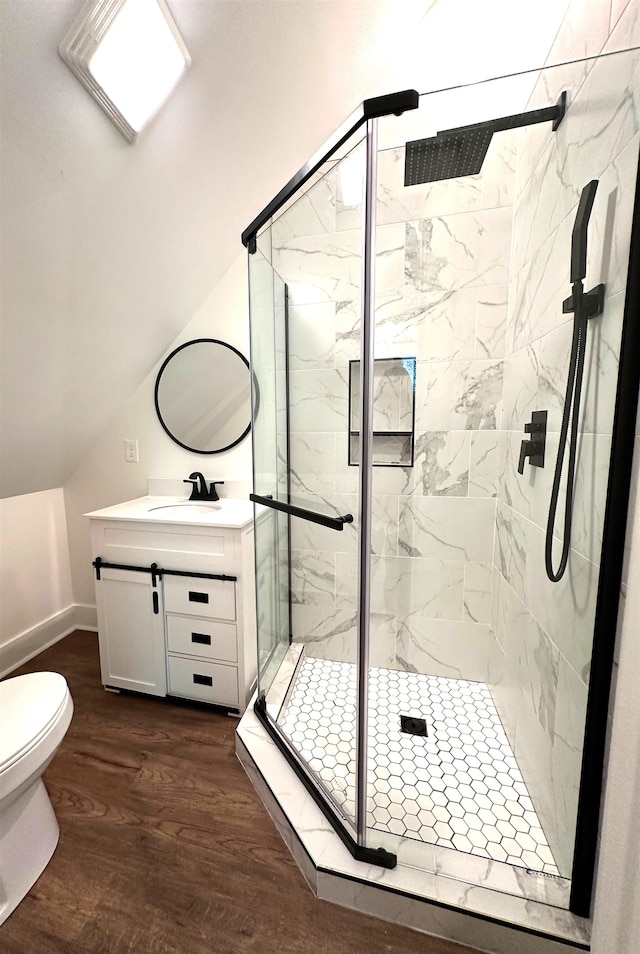 bathroom featuring walk in shower, large vanity, toilet, and hardwood / wood-style floors