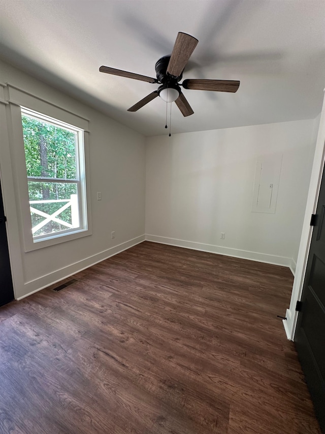 spare room with dark hardwood / wood-style floors and ceiling fan