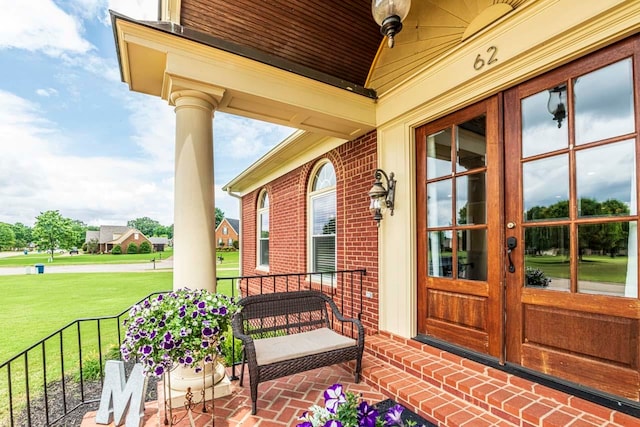 view of exterior entry with a yard