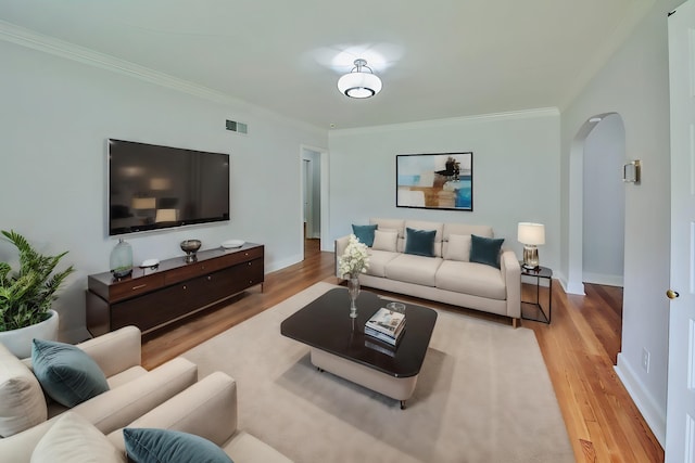 living room with hardwood / wood-style floors and crown molding