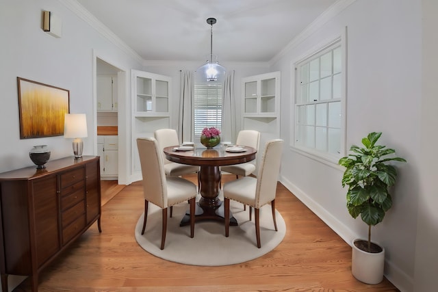 dining room featuring ornamental molding and light hardwood / wood-style flooring