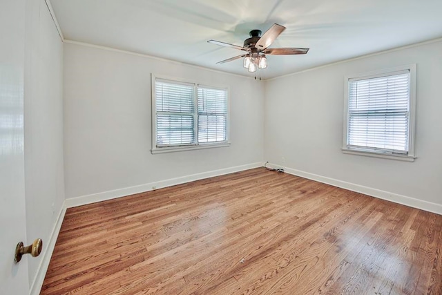 spare room featuring light hardwood / wood-style floors, crown molding, and ceiling fan