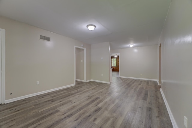 unfurnished room with hardwood / wood-style flooring