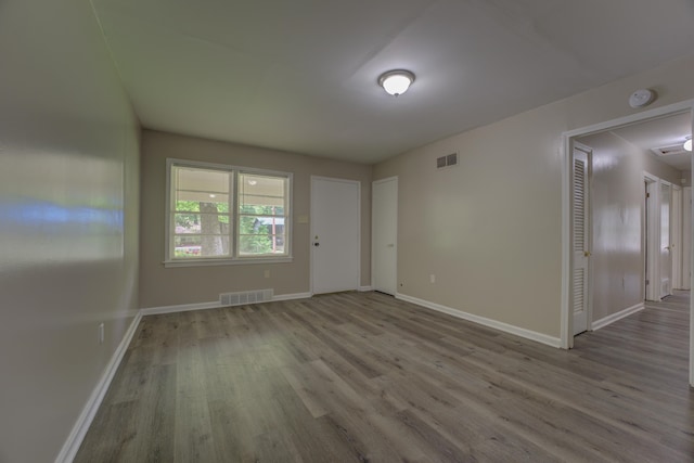 unfurnished room featuring wood-type flooring