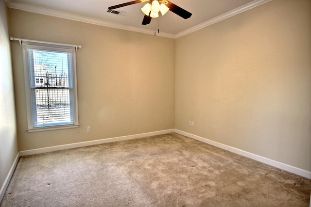 carpeted empty room with ornamental molding and ceiling fan