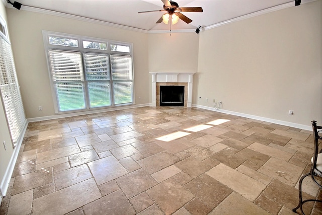 unfurnished living room with a tile fireplace, crown molding, and ceiling fan