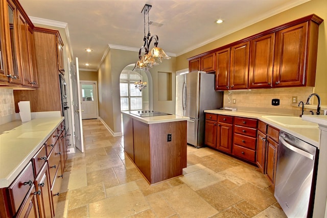 kitchen featuring pendant lighting, a center island, tasteful backsplash, a notable chandelier, and appliances with stainless steel finishes