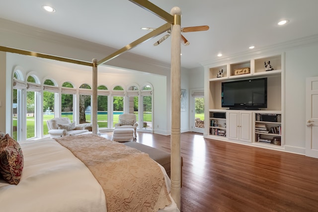 bedroom with hardwood / wood-style flooring, ornamental molding, and ceiling fan