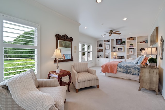 bedroom featuring ornamental molding, ceiling fan, carpet floors, and multiple windows