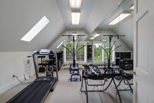 workout area featuring vaulted ceiling with skylight and carpet flooring