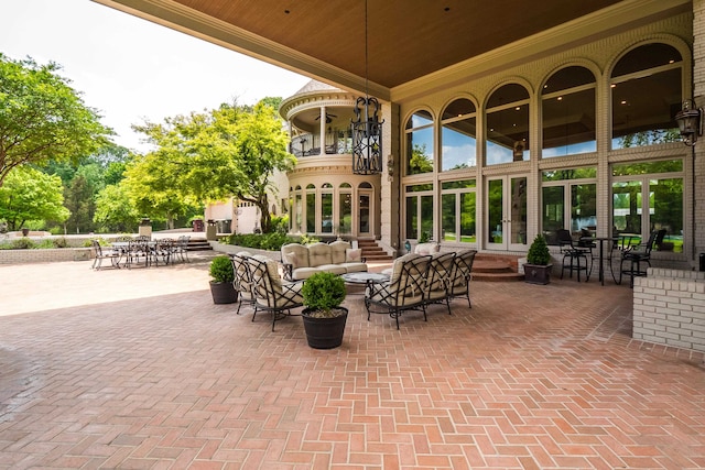 view of patio / terrace featuring outdoor lounge area, french doors, and a balcony