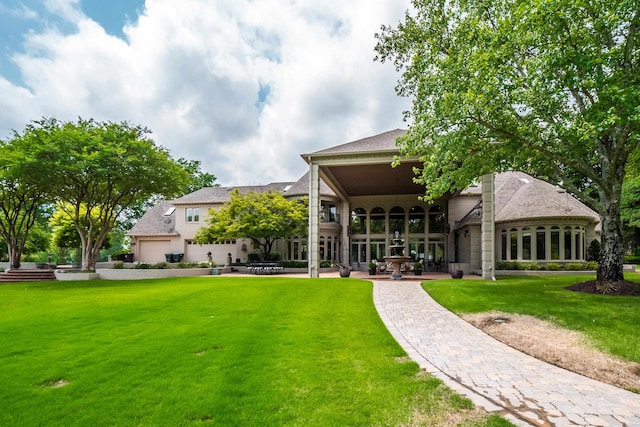 rear view of property with a patio, a yard, and ceiling fan