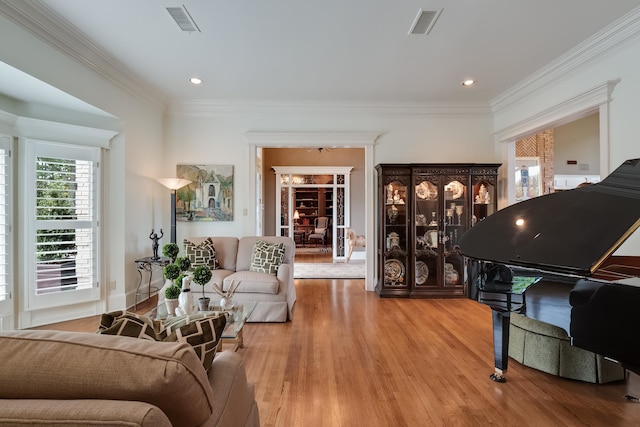 living room with ornamental molding and hardwood / wood-style floors