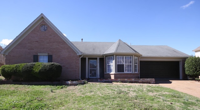 view of front of home featuring a garage and a front lawn