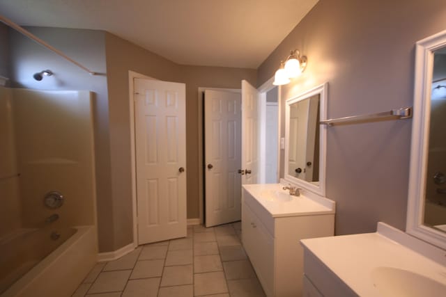 bathroom with tile flooring, shower / washtub combination, double sink, and vanity with extensive cabinet space