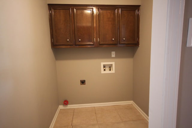 laundry area featuring cabinets, washer hookup, light tile flooring, and hookup for an electric dryer