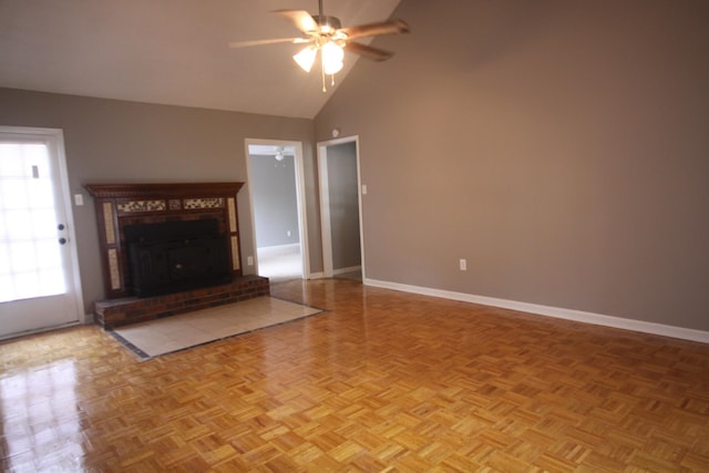 unfurnished living room featuring a fireplace, plenty of natural light, ceiling fan, and light parquet flooring