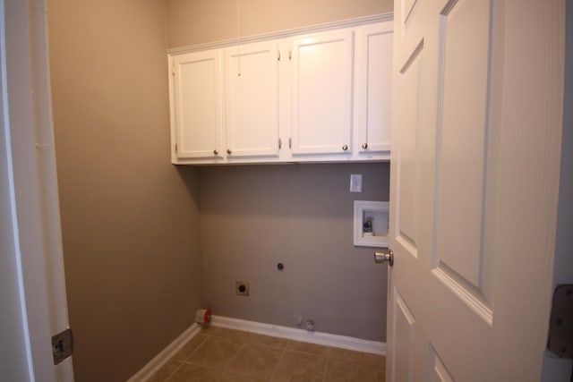 laundry room featuring cabinets, hookup for an electric dryer, hookup for a washing machine, hookup for a gas dryer, and dark tile floors