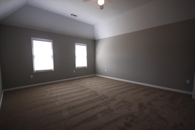 carpeted empty room with ceiling fan and vaulted ceiling