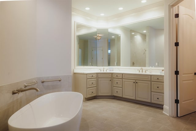 bathroom with tile flooring, ornamental molding, double sink, a bath to relax in, and oversized vanity