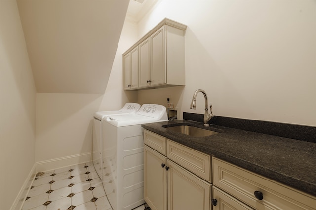 laundry room featuring washing machine and clothes dryer, washer hookup, light tile floors, sink, and cabinets