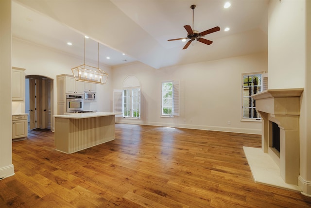 kitchen with appliances with stainless steel finishes, a center island, and light hardwood / wood-style flooring