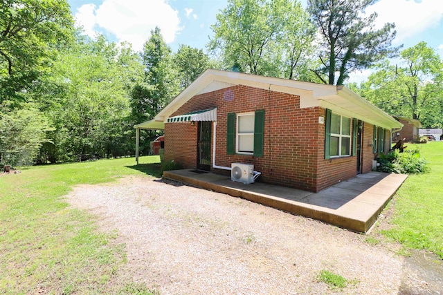 view of front of house with a front lawn and central AC unit