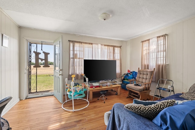 living room with light hardwood / wood-style floors and a textured ceiling