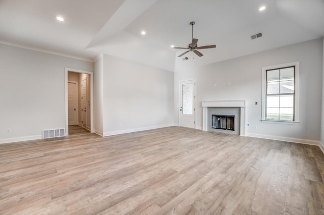 unfurnished living room with ceiling fan, ornamental molding, light wood-type flooring, and lofted ceiling