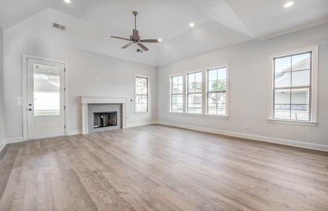 unfurnished living room with ceiling fan, a healthy amount of sunlight, and light wood-type flooring