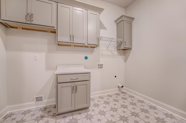 clothes washing area with hookup for a washing machine, baseboards, hookup for an electric dryer, and light floors