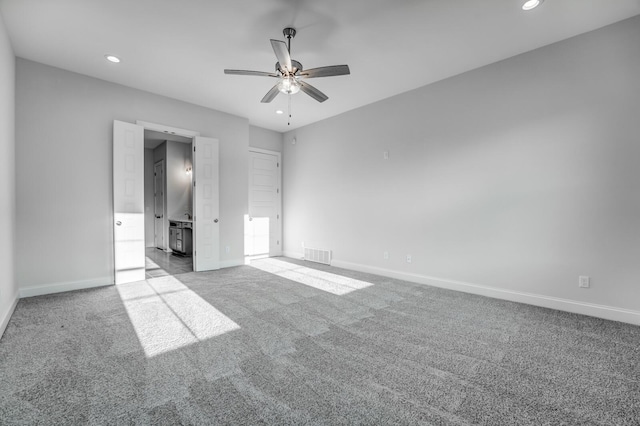 spare room featuring ceiling fan and light colored carpet