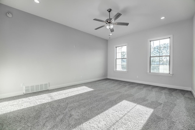 unfurnished room with ceiling fan and carpet floors