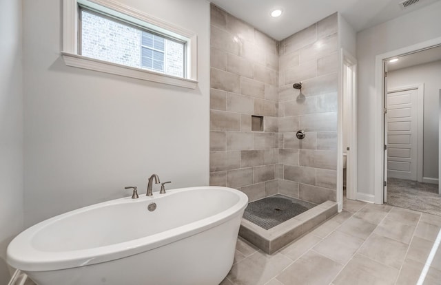 bathroom featuring recessed lighting, visible vents, a shower stall, tile patterned flooring, and a freestanding tub