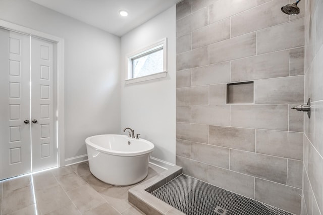 bathroom with tile patterned floors and separate shower and tub