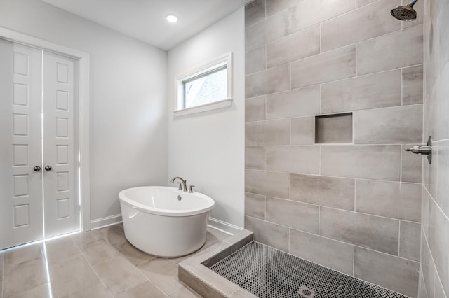 full bathroom with baseboards, a soaking tub, tile patterned floors, a tile shower, and recessed lighting