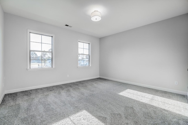 unfurnished room with plenty of natural light and carpet floors