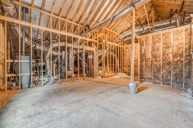 miscellaneous room with gas water heater and vaulted ceiling