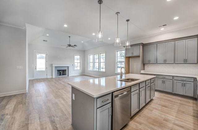 kitchen with ceiling fan, light wood-type flooring, stainless steel dishwasher, backsplash, and sink