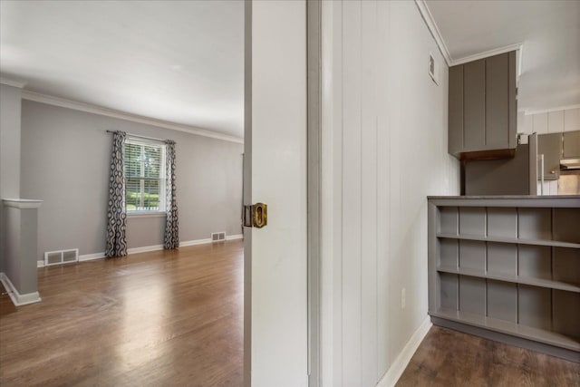 hall featuring dark wood-type flooring and crown molding