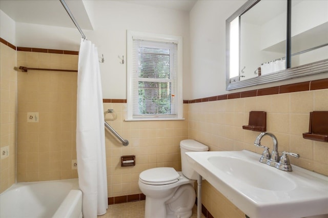 full bathroom with tile walls, shower / tub combo with curtain, and toilet