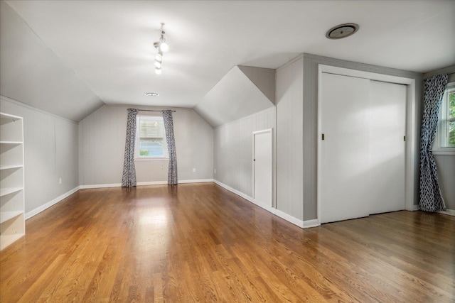 bonus room featuring light hardwood / wood-style floors and lofted ceiling