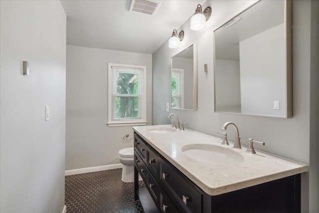 bathroom with dual bowl vanity, toilet, and tile floors