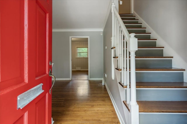 stairway featuring ornamental molding and hardwood / wood-style floors