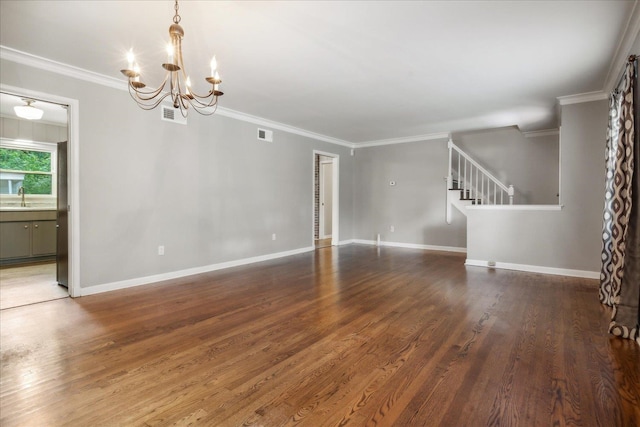 unfurnished living room with crown molding, sink, an inviting chandelier, and hardwood / wood-style floors