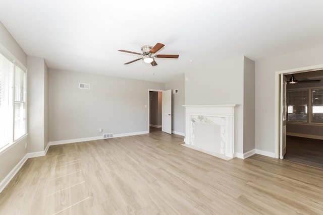 unfurnished living room featuring light hardwood / wood-style floors, a healthy amount of sunlight, and ceiling fan