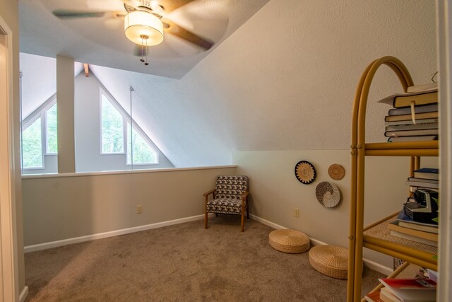 unfurnished room with lofted ceiling, carpet floors, and ceiling fan