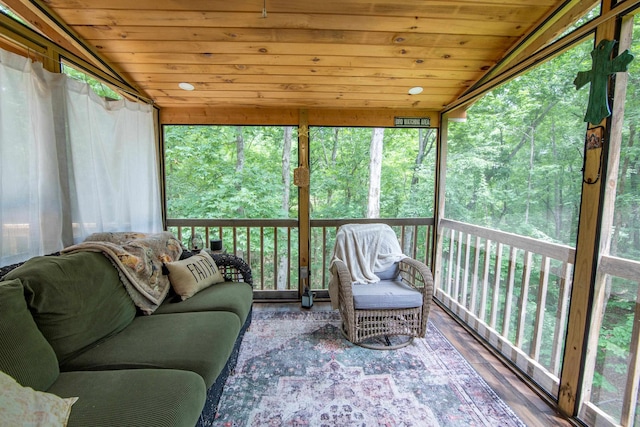 sunroom with a wealth of natural light, vaulted ceiling, and wood ceiling