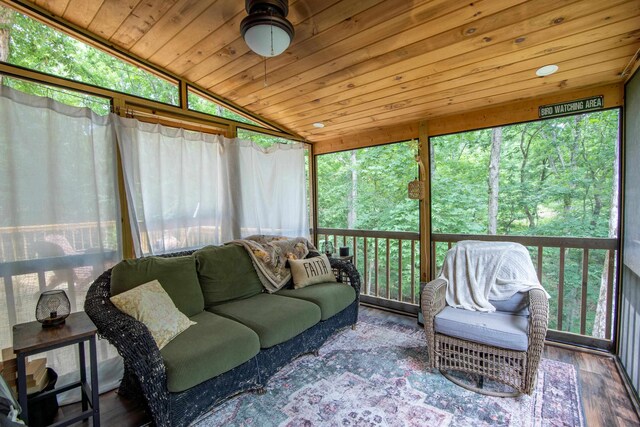 sunroom with plenty of natural light, vaulted ceiling, and wood ceiling