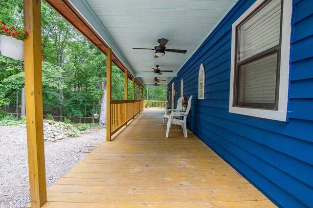 wooden terrace featuring ceiling fan